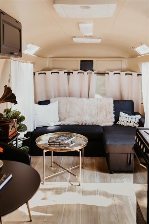 living area featuring lofted ceiling and wood finish floors