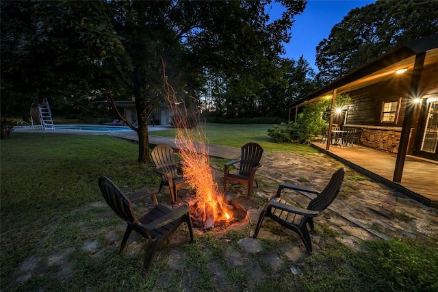 view of patio featuring an outdoor fire pit and an outdoor pool