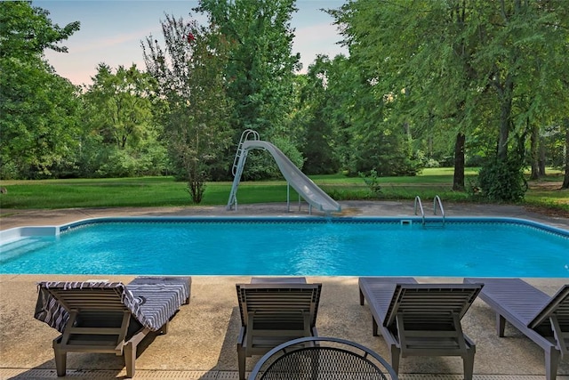 pool featuring a yard and a water slide