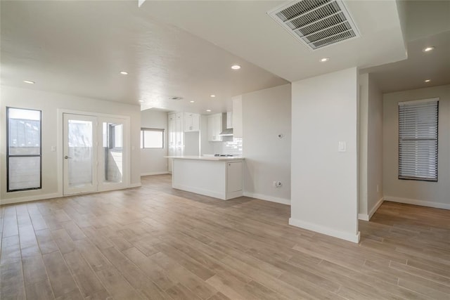 unfurnished living room featuring recessed lighting, visible vents, and light wood-style floors