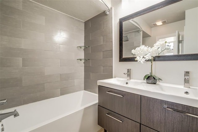 bathroom featuring a sink, double vanity, shower / tub combination, and visible vents