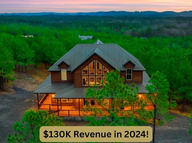 64 Buttonwood Trl, Broken Bow, OK 74728 - exterior space with a mountain view, metal roof, and a view of trees