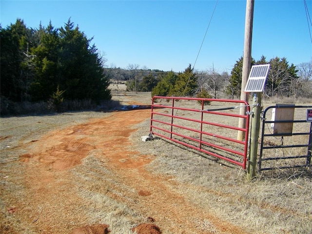 view of gate with a rural view