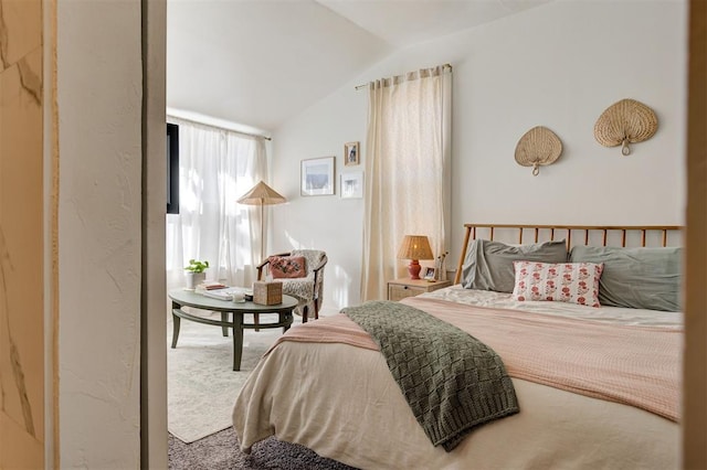 carpeted bedroom featuring vaulted ceiling