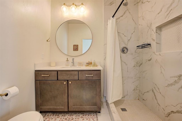 bathroom featuring toilet, a shower stall, and vanity