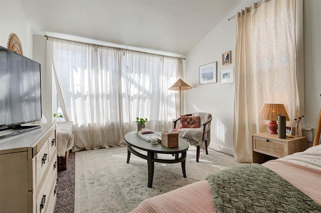 interior space featuring vaulted ceiling, light carpet, and plenty of natural light