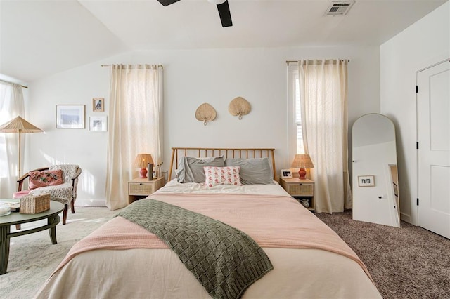 carpeted bedroom with ceiling fan, visible vents, and vaulted ceiling