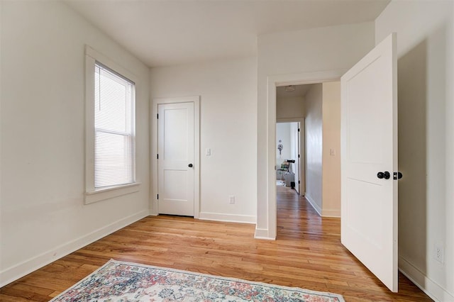 bedroom with light wood-type flooring and baseboards