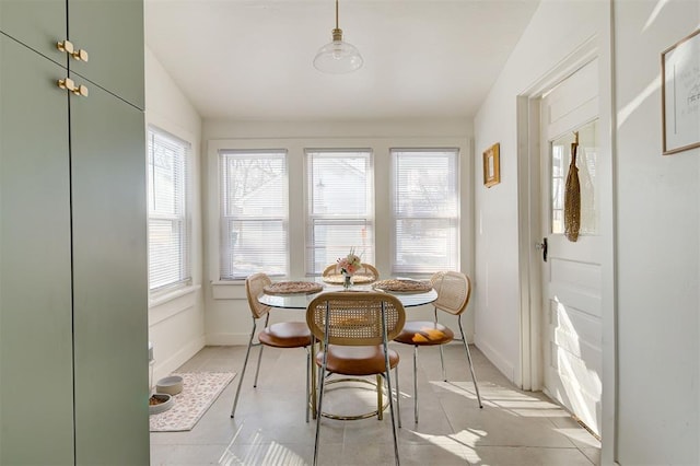 dining area with baseboards and vaulted ceiling