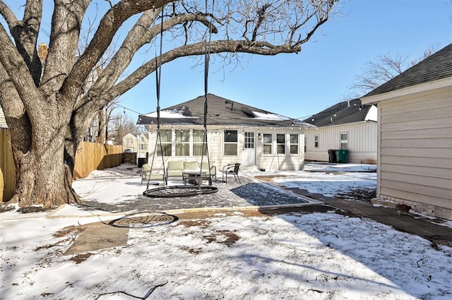 snow covered property featuring fence