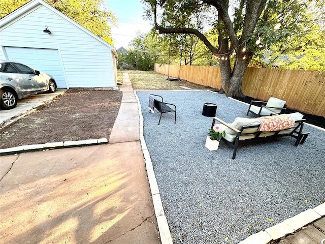 view of yard with a garage and a fenced backyard