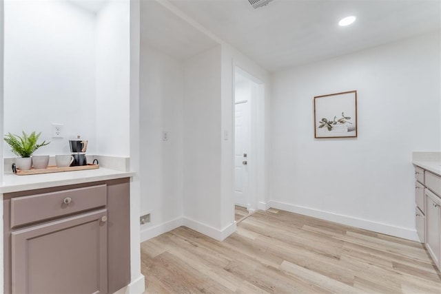 bathroom featuring recessed lighting, wood finished floors, vanity, and baseboards