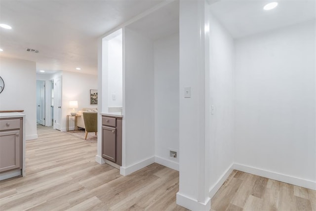 hallway featuring baseboards, recessed lighting, visible vents, and light wood-style floors