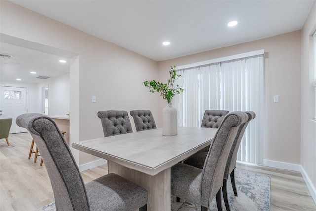 dining space with light wood finished floors, baseboards, and recessed lighting