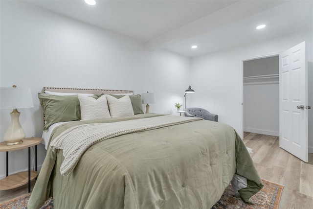 bedroom featuring baseboards, a closet, light wood-type flooring, and recessed lighting