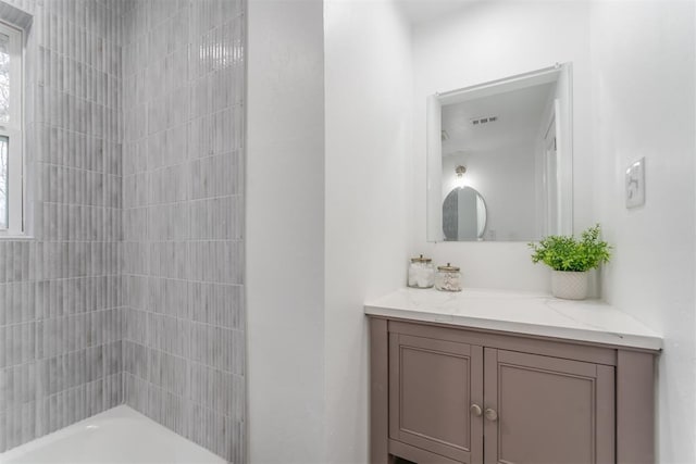 full bath featuring visible vents, a wealth of natural light, tub / shower combination, and vanity