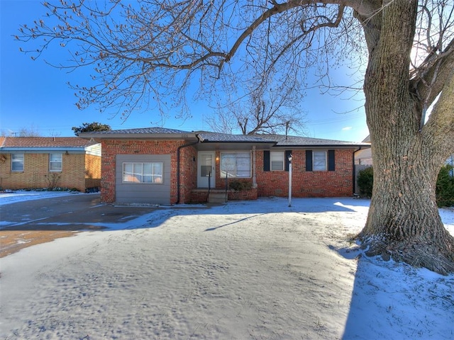 ranch-style home featuring brick siding and driveway