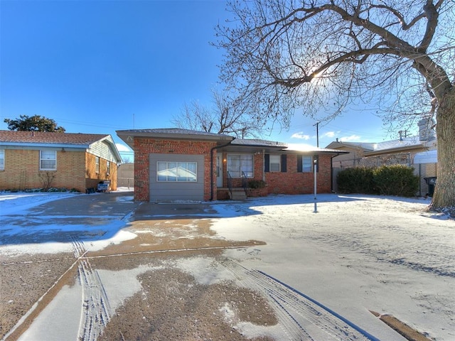 single story home featuring concrete driveway, brick siding, and an attached garage