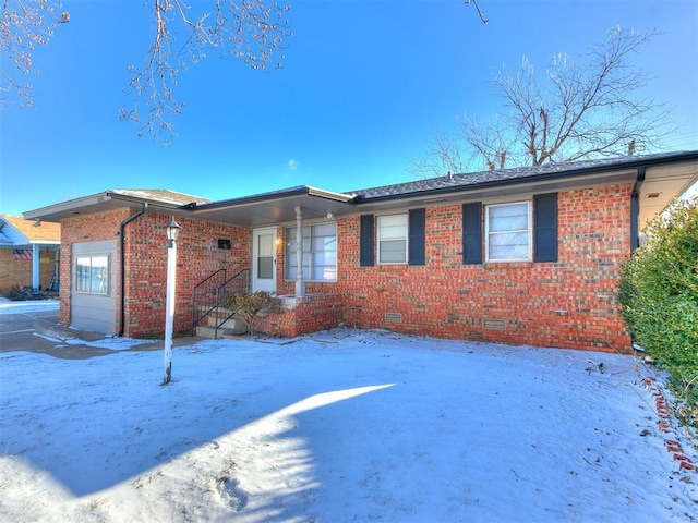 ranch-style house with crawl space, an attached garage, and brick siding