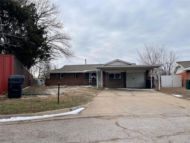 single story home featuring a garage, concrete driveway, and brick siding