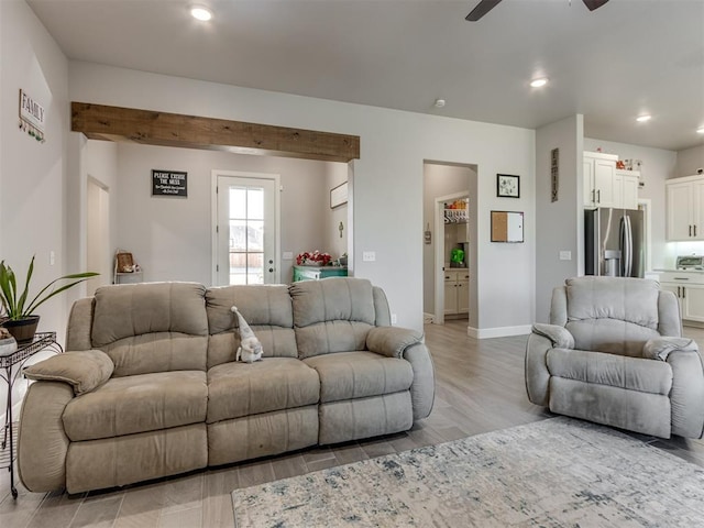 living room featuring ceiling fan, light wood-style floors, baseboards, and recessed lighting