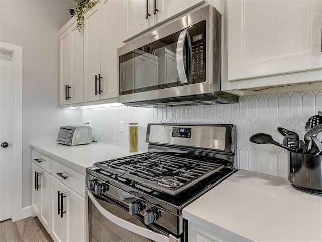 kitchen featuring stainless steel appliances and white cabinets