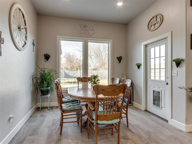 dining room with light wood finished floors and baseboards