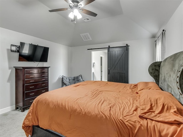 bedroom featuring a barn door, visible vents, baseboards, light colored carpet, and lofted ceiling