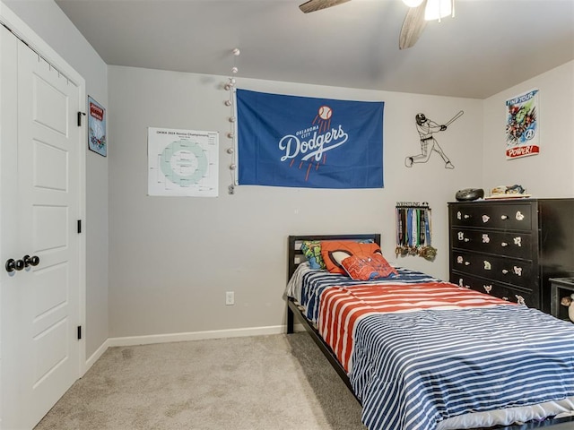 carpeted bedroom featuring ceiling fan and baseboards