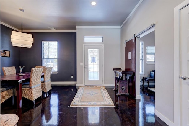 entrance foyer with ornamental molding, a barn door, visible vents, and baseboards