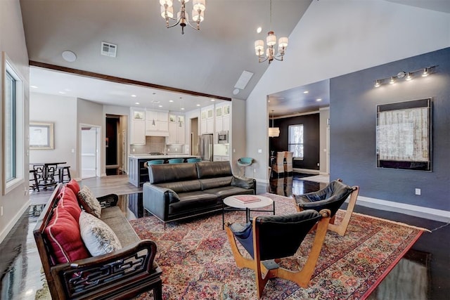 living area featuring a chandelier, high vaulted ceiling, visible vents, and baseboards