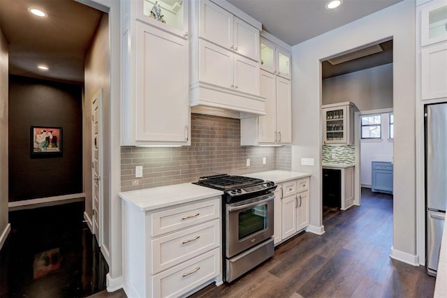 kitchen with light countertops, appliances with stainless steel finishes, and glass insert cabinets