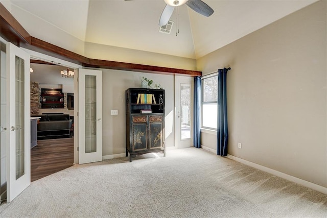 spare room with baseboards, visible vents, carpet flooring, french doors, and high vaulted ceiling