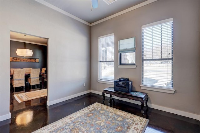 living area featuring finished concrete flooring, baseboards, a ceiling fan, and ornamental molding