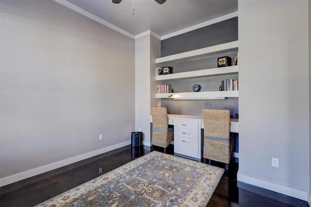 office featuring baseboards, built in features, ceiling fan, ornamental molding, and built in desk