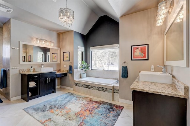 full bath with a bath, a sink, visible vents, and tile patterned floors