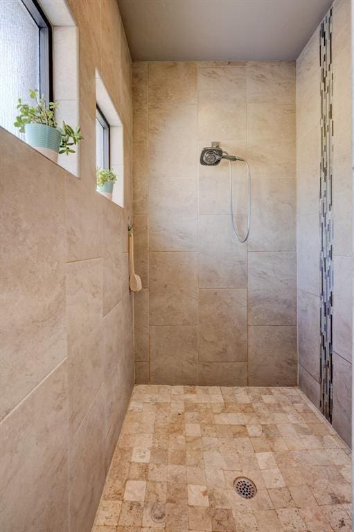 bathroom with tiled shower