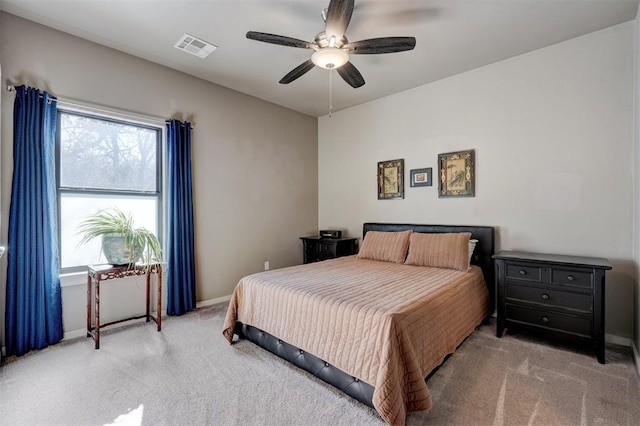 bedroom with light carpet, baseboards, visible vents, and a ceiling fan