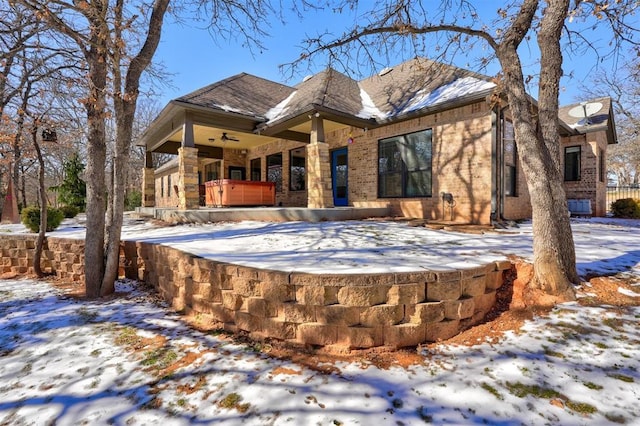 view of front facade with a hot tub and brick siding