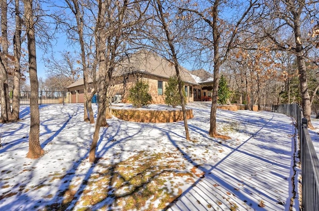 yard covered in snow with fence