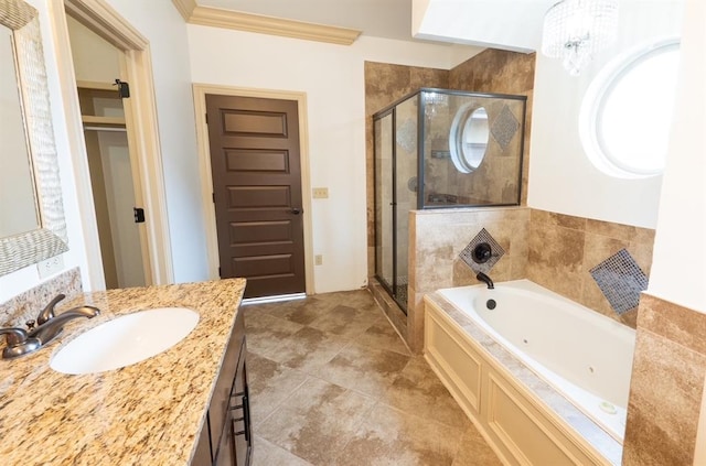 bathroom with a stall shower, ornamental molding, a garden tub, and vanity