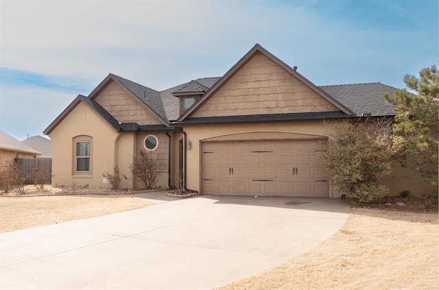 view of front of home with concrete driveway, a garage, and roof with shingles