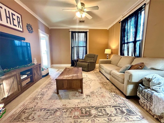 living room featuring baseboards, ornamental molding, visible vents, and a ceiling fan