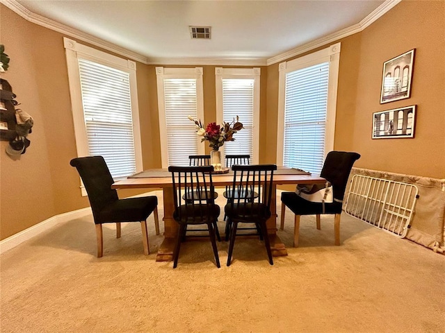 dining area featuring ornamental molding, visible vents, light carpet, and baseboards