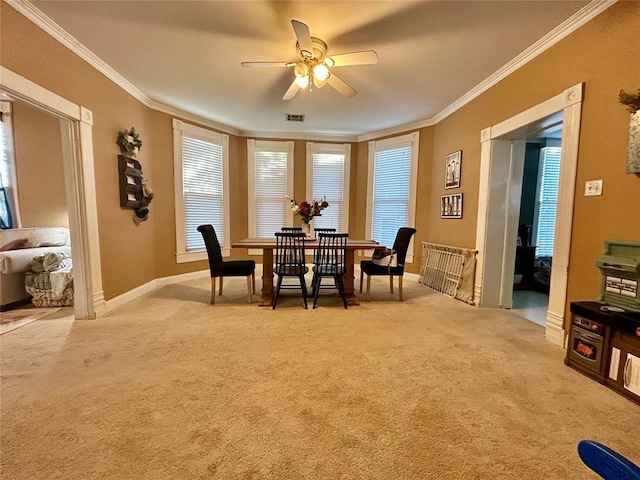 dining space with ornamental molding, carpet flooring, and visible vents