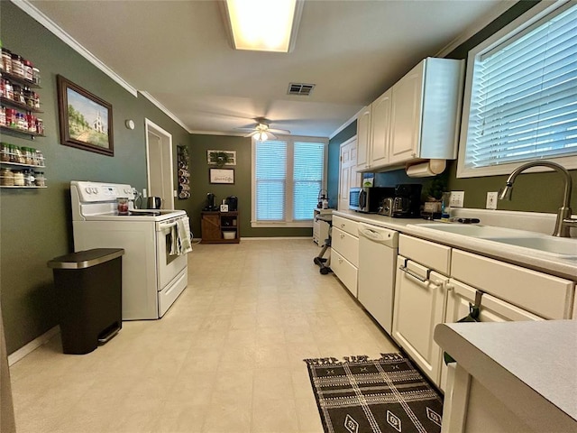 kitchen featuring white appliances, visible vents, light countertops, white cabinetry, and a sink