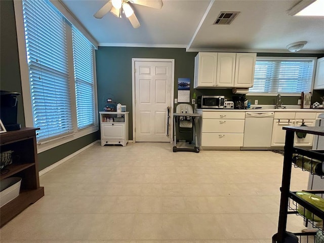 kitchen with visible vents, white cabinets, stainless steel microwave, white dishwasher, and light countertops