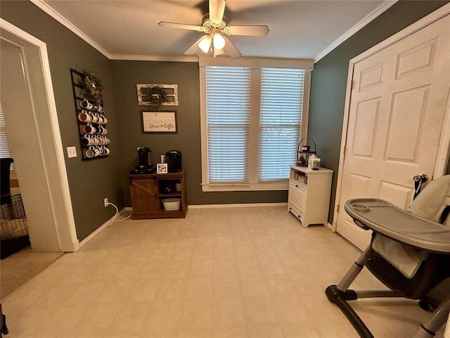 office featuring ornamental molding, baseboards, light floors, and a ceiling fan