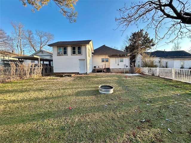 back of property featuring entry steps, crawl space, a fenced backyard, and a yard