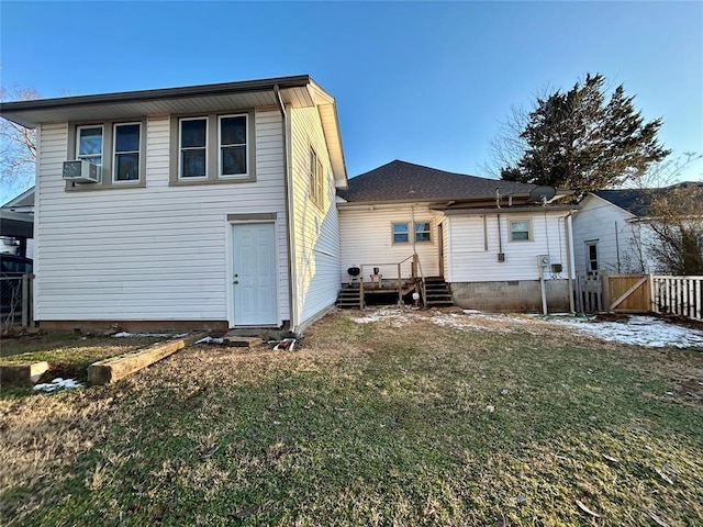 back of property featuring a lawn, cooling unit, and fence